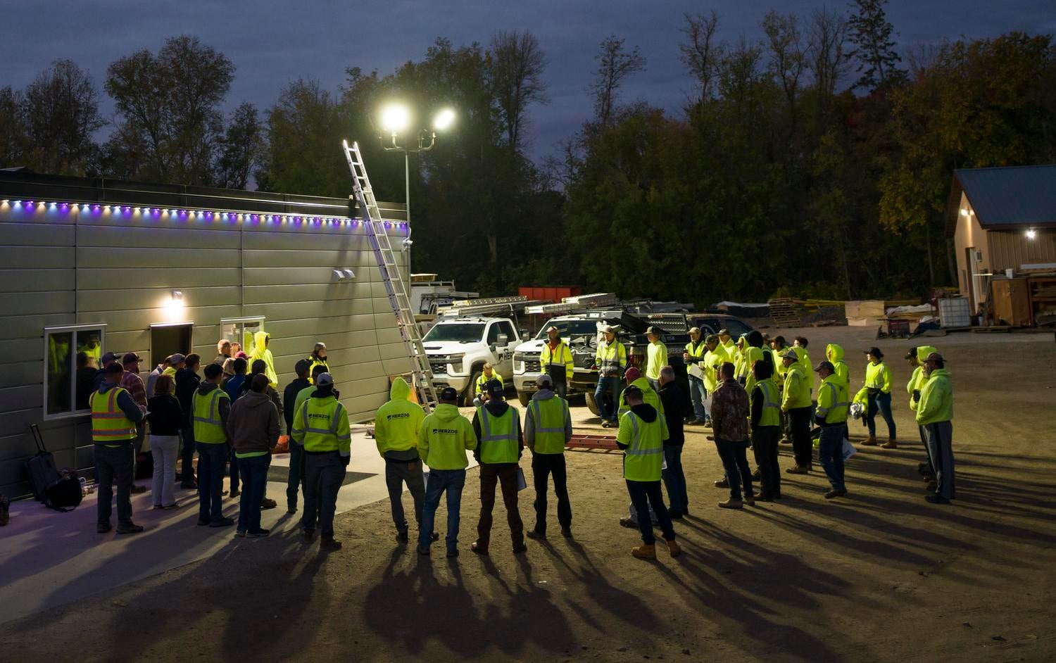 Herzog crew gathers for a pre-dawn toolbox talk on ladder safety